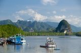 Once a simple fishing harbor, Krabi is becoming an eco-tourism center, as well as the main ferry embarkation point for islands such as Ko Lanta to the south, Ko Phi Phi to the southwest, and the beaches around Ao Nang to the west.<br/><br/>

Set on the banks of the Krabi Estuary, the town is said to take its name from a sword or krabi allegedly discovered nearby. Krabi’s surroundings are distinguished by towering limestone outcrops, a kind of Phang Nga Bay on land, and these have become the symbol of Krabi Province. Among the most notable are Khao Khanap Nam, twin limestone peaks, which stand like sentinels at each side of the Krabi River. To the east, the town is hemmed in by mangrove-lined shorelines.